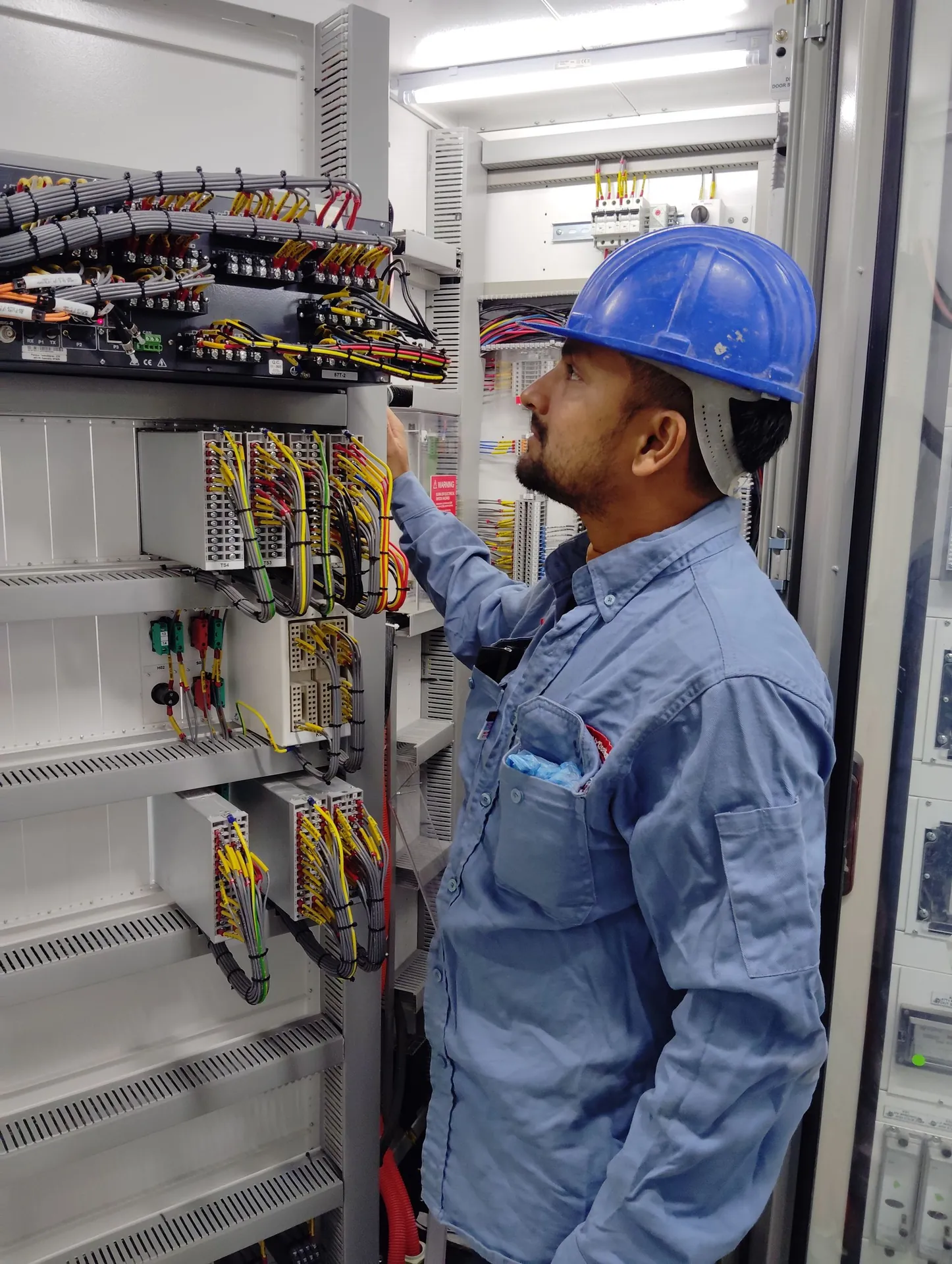 Electrician terminating cables on site