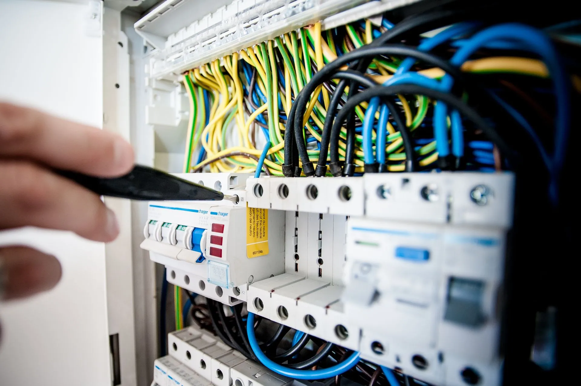 Electrician working on an opened switchboard