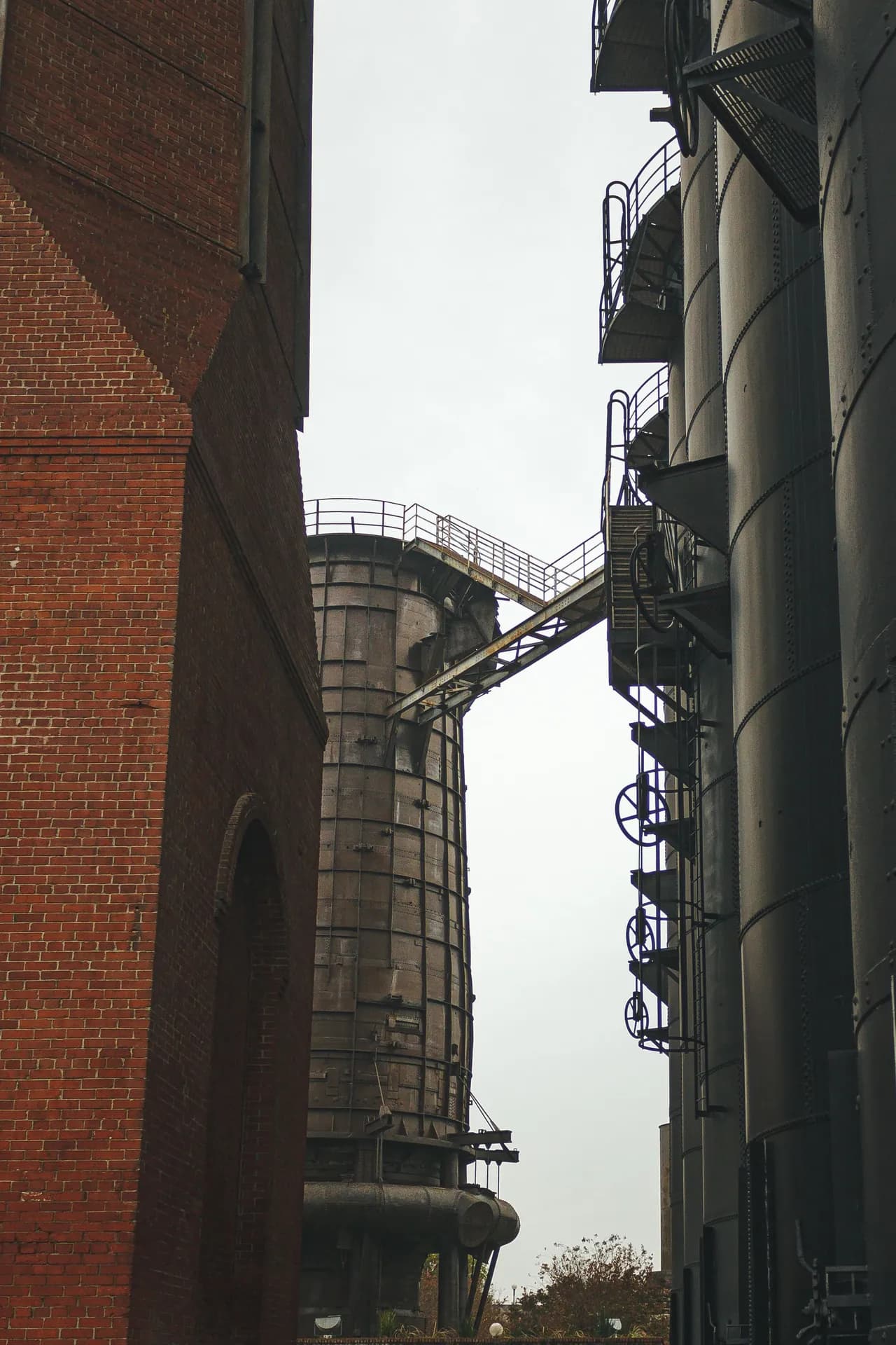 Lit passage between industrial buildings