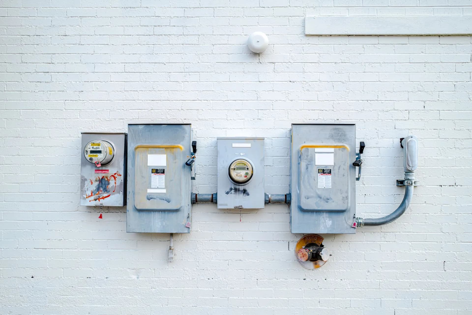 Row of electrical meter enclosures mounted on a wall