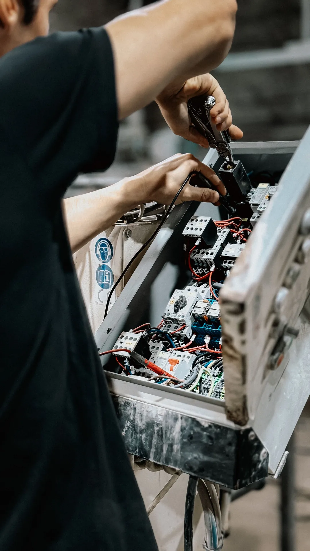 Technician working on an automation control panel