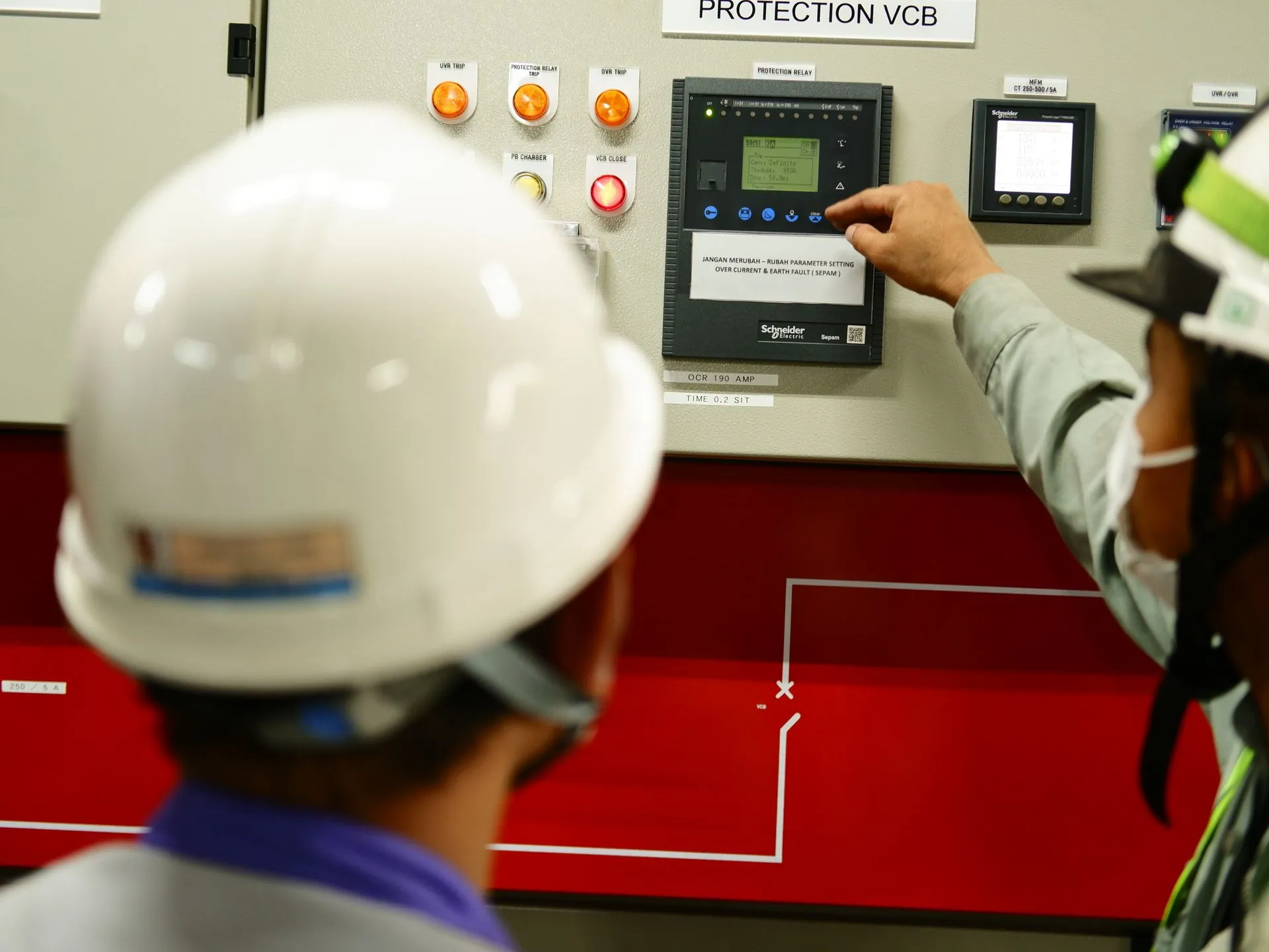 Technicians assembling equipment on an industrial production floor