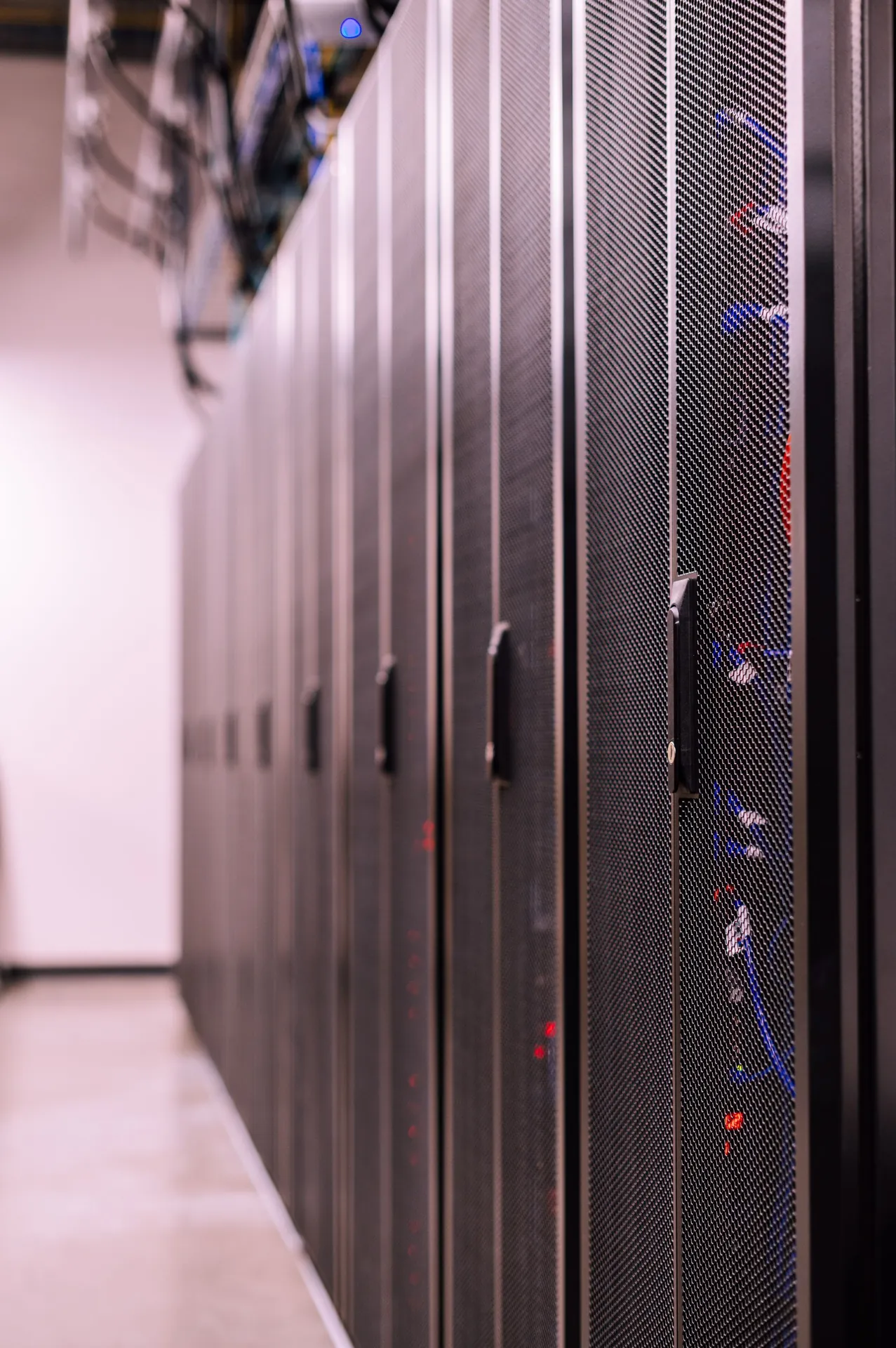 Rows of cabinets and fibre trunking in a data hall