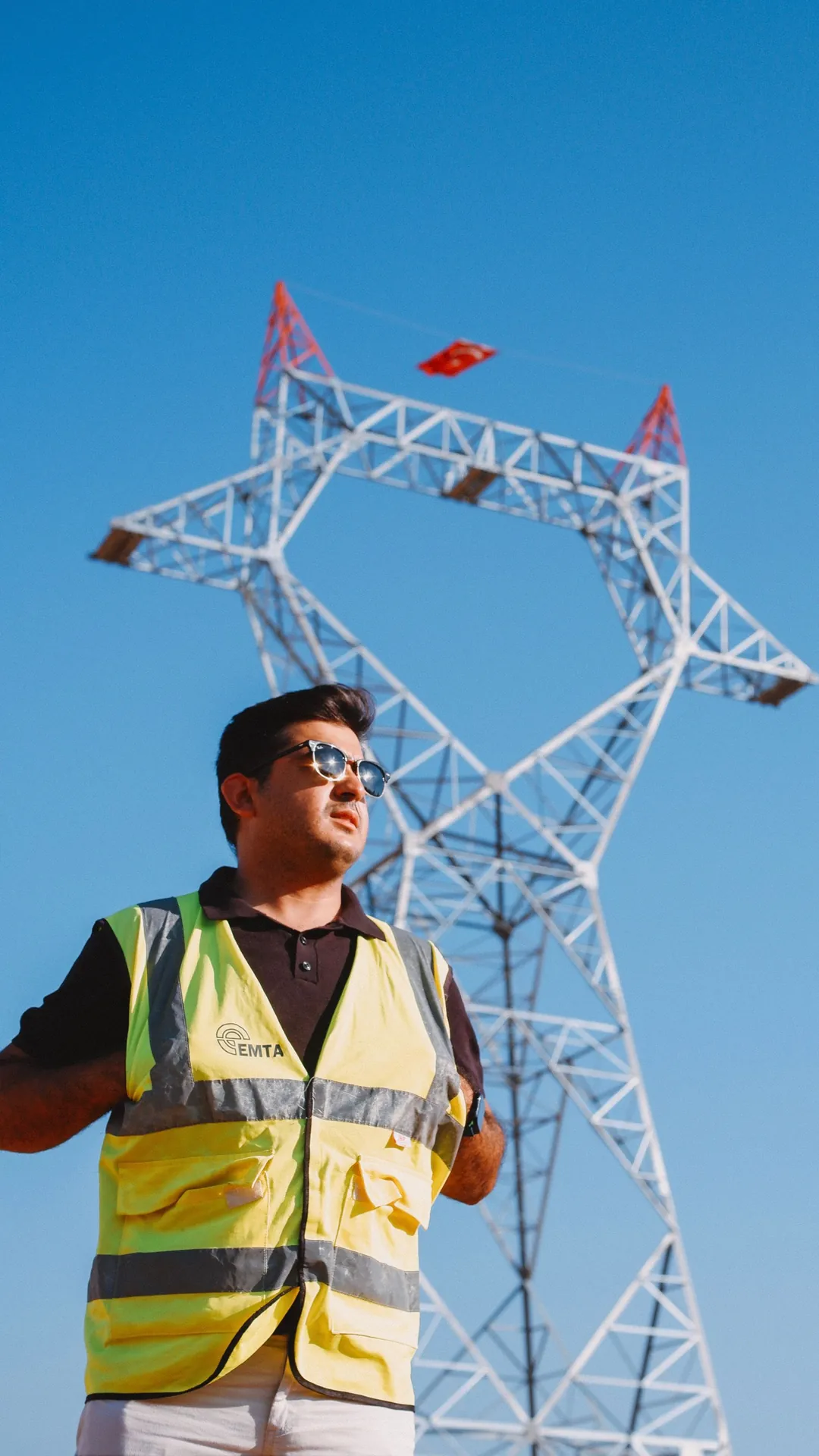 Engineer inspecting a power transmission tower